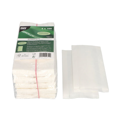 A stack of PAPSTAR greaseproof sandwich bags, 21x10x3 cm, white (500 pieces), lies next to three spread-out bags on a white background - ideal for keeping snacks and sandwiches fresh.