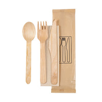 The Duni GmbH 4/1 cutlery set, made of naturally waxed wood, includes a fork, knife, spoon, and brown napkin (160/165/160), hygienically packaged in sets of 250—shown here in an eco-friendly design on a white background next to an illustrated paper bag.