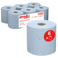 The image shows six blue rolls of WypAll® L20 paper towels for industrial cleaning tasks from Kimberly-Clark GmbH, packaged with one roll in front and five in the back for central dispensing. A red label indicates that the package contains 6 rolls (38.00 x 18.30 cm).