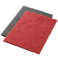 Two Twister pads from Diversey Deutschland GmbH & Co. OHG—one red and one gray—lie flat and partially overlapping on a white background—ideal for scrubbing and deep cleaning.