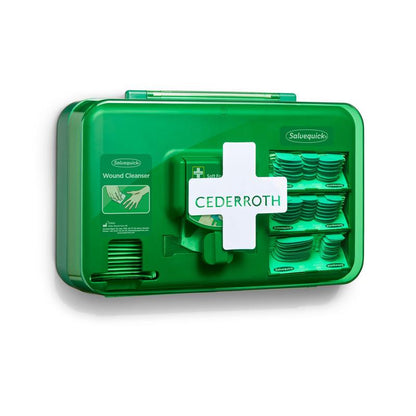 A blue Orkla Wound Care AB wound care dispenser (1 pack), wall-mounted, contains compartments with wound cleansing wipes and adhesive bandages. The device is marked with a white cross symbol for easy identification.