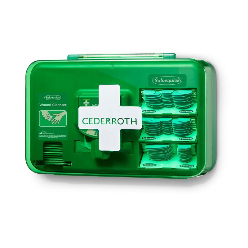 A blue Orkla Wound Care AB wound care dispenser (1 pack), mounted on a white wall, with several compartments for Salvequick wound cleansing wipes and plasters.