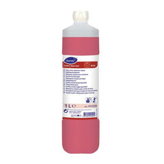 Le nettoyant de base pour sanitaires TASKI Sani Ami de 1 l, commercialisé par Diversey Deutschland GmbH & Co. OHG, utilise des agents actifs alcalins et complexants pour éliminer les salissures tenaces ; il est livré avec un bouchon blanc et une étiquette multilingue pour faciliter son utilisation.