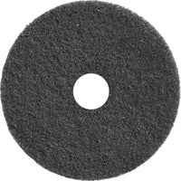 A round, black TASKI Americo Dominator Pad, 17" (43 cm), from Diversey Deutschland GmbH & Co. OHG, with a rough texture and a center hole—an extra-aggressive deep-cleaning pad, ideal for intensive floor cleaning (pack: 1 piece).