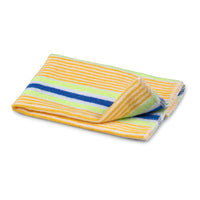 A folded towel with yellow, green, and blue stripes on a white background, ideal for gentle cleaning, such as the Nölle Profi Brush cotton dust cloth from Nölle Profi Brush Bürsten- & Pinseltechnik e.K.