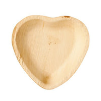 The PAPSTAR "Pure" heart-shaped palm leaf plate (15.5 x 3 cm), made from sustainable palm leaves, comes in a pack of 25—biodegradable disposable tableware, ideal for eco-friendly parties.