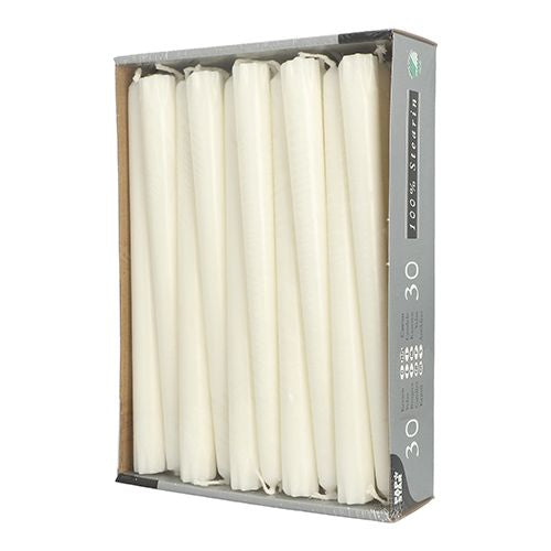 A rectangular cardboard tray from PAPSTAR GmbH holds 30 white taper candles (24 cm, Ø 2.2 cm, 100% stearin) in a vertical arrangement; the partially opened packaging shows the candles and a gray sidewall with text and icons.