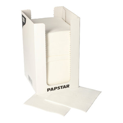 A white cardboard dispenser with the inscription "PAPSTAR GmbH" contains a stack of PAPSTAR 100 napkins, 2-ply "PUNTO" 1/4-fold, 20x20 cm; two napkins are partially pulled out and placed in front of the box.