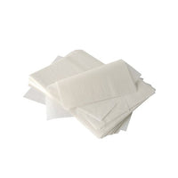 A stack of semi-transparent PAPSTAR "Pure" cream-covering paper (32x22 cm, white, palm wax coating, 1,000 sheets) from the PAPSTAR The "GmbH" logo is set against a white background—perfect for use in the food service industry; some sheets are flat, while others are folded or overlapping.