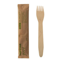 One PAPSTAR "Pure" wooden fork, 15.5 cm, individually wrapped in shrink wrap (50 pieces), lying next to its unopened brown packaging from PAPSTAR A GmbH with green lettering and a simple design.
