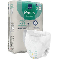 A package of ABENA Pants Junior Premium, Size XS2, from Abena Re-Seller GmbH is shown in the foreground with an unfolded diaper. The beige package with green and blue accents contains 18 X-small diapers.