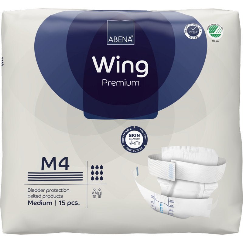 Un paquet d'ABENA Wing Premium par Abena Re-Seller GmbH (moyen, 15 pièces) avec emballage offrant protection et confort, images du produit, logo de la marque et symboles pour l'absorption et la protection de la peau.