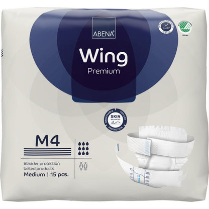 Un paquet d'ABENA Wing Premium par Abena Re-Seller GmbH (moyen, 15 pièces) avec emballage offrant protection et confort, images du produit, logo de la marque et symboles pour l'absorption et la protection de la peau.