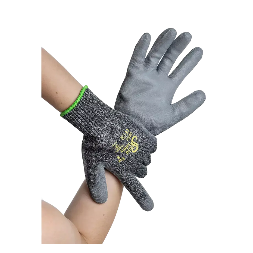 Two hands are wearing AMPri SolidSafety Cut High cut-resistant gloves, gray work gloves made of cut-resistant material. These gloves from AMPri Handelsgesellschaft mbH feature a textured surface with yellow-white text on the back and have a green cuff at the wrist that provides both durability and protection.