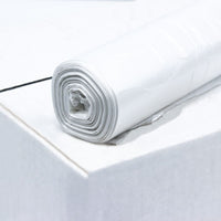 Un rouleau de sacs poubelle DEISS en PEHD de 80 litres, référence 56095, de couleur blanche, fabriqué par EMIL DEISS KG (GmbH + Co.), est posé sur un carton. Le rouleau est bien enroulé, tandis que la surface du carton semble lisse et propre.