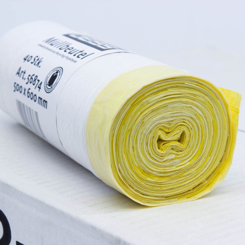 Eine aufgerollte Packung DEISS Müllbeutel 56874 30 Liter mit Zugband von EMIL DEISS KG (GmbH + Co.), mit gelben und weißen Plastikmüllsäcken auf weißem Untergrund. Das Etikett auf der Rolle weist die Maße 500 x 600 mm auf und gibt an, dass sie 40 Stück mit einem Fassungsvermögen von jeweils 30 Litern enthält.