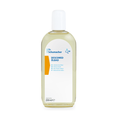 Une bouteille en plastique transparent munie d'un bouchon blanc contient le bain d'huile Dr. Schumacher Descomed | Bouteille (250 ml) de la société Dr. Schumacher GmbH. L'étiquette multilingue fournit des informations sur le produit et sa contenance ; ce produit est idéal pour le soin des peaux sèches.
