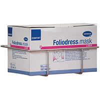 Eine Novocal Mundschutzboxhalterung aus rostfreiem Stahl (zur Befestigung an der Euroschiene, 1 Stück/Packung) hält eine rechteckige Box mit der Aufschrift "Foliodress mask", die Einweg-Gesichtsmasken enthält. Marke: Novocal.