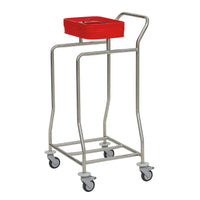 The Novocal "Kompakt plus" single-bin stainless steel laundry cart is made of stainless steel, has four casters, and features a red square bin for hygienic laundry organization in medical facilities.