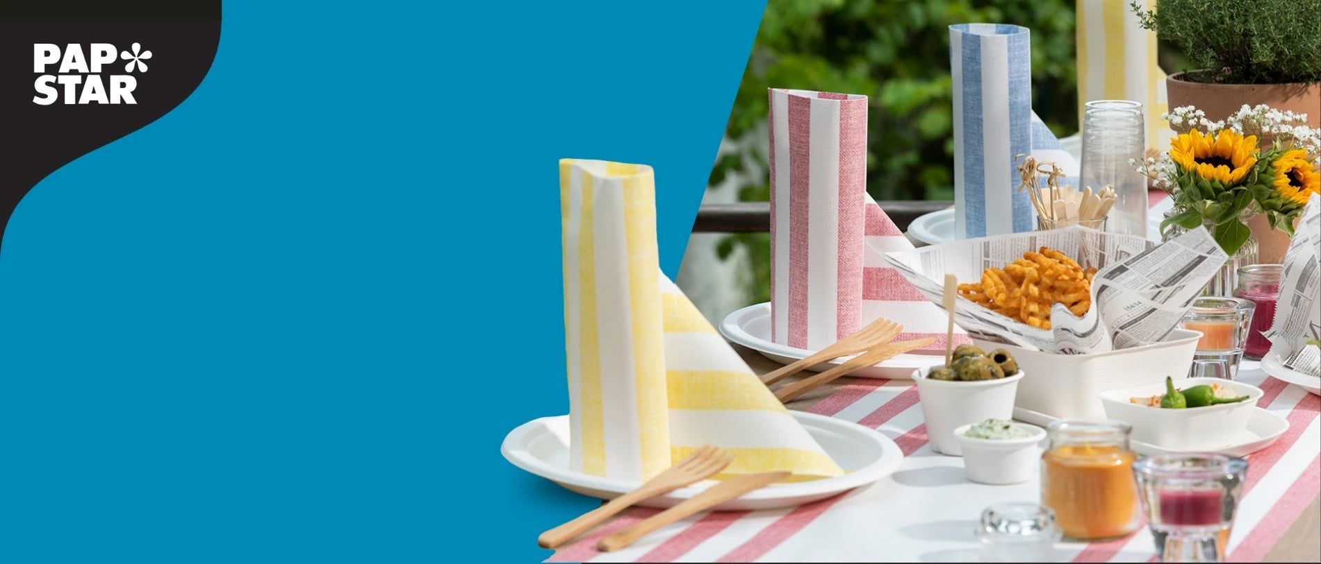 PAPSTAR Banner mit frühlingshaft gedecktem Tisch, bunten Servietten, Einweggeschirr, Holz-Besteck und kleinen Snacks für saisonale Tischdekoration.