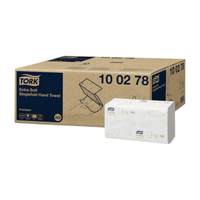 The packaging for Tork 100278 Extra Soft Zigzag Premium H3 2-Ply Hand Towels combines hygiene and elegance with its brown-and-white design. The larger brown box displays the product details, while the smaller white box highlights the Premium H3 towel design with green leaf motifs and the Tork logo, which represents the TORK – Essity Professional Hygiene Germany GmbH brand.
