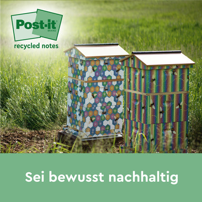 Zwei dekorierte Bienenstöcke stehen auf einer Wiese, links oben ist das Logo der Post-it® Super Sticky 100% Recycling Notes (47,6 x 47,6 mm, 70 Blatt/Block, 100% PEFC) von 3M Deutschland GmbH zu sehen. Der deutsche Text lautet: "Sei bewusst nachhaltig.