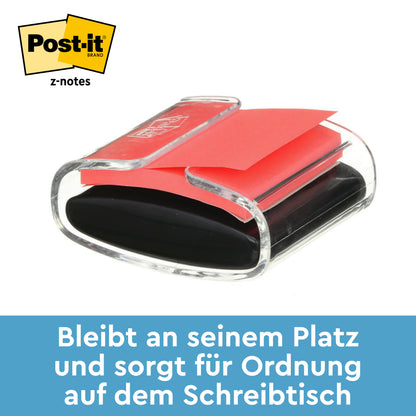 Ein schwarzer Post-it® Z-Notes Dispenser der 3M Deutschland GmbH mit gelben Super Sticky Z-Notes (76x76 mm, 90 Blatt) ist auf weißem Hintergrund abgebildet. Der deutsche Text lautet: "Bleibt an seinem Platz und sorgt für Ordnung auf dem Schreibtisch.